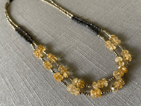 top view of gemstone bead necklace comprising yellow citrine, dark bronze and golden pyrite