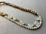 top view of gemstone bead necklace comprising white chalcendony, off-white Siberian moonstone and exotic wood