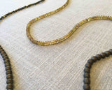 closeup of gemstone bead necklace comprising yellow sapphire, pyrite and bronze hematite