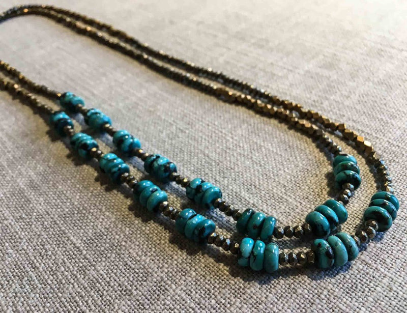 top view of gemstone bead necklace comprising turquoise, bronze and dark grey pyrite