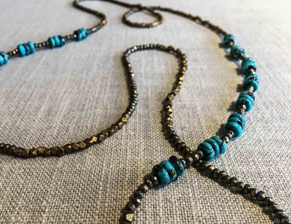 closeup of gemstone bead necklace comprising turquoise, bronze and pyrite