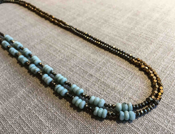 top view of gemstone bead necklace comprising blue lace agate, bronze and dark grey pyrite