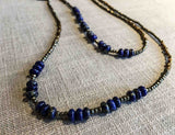 closeup of gemstone bead necklace comprising dark blue lapis, bronze and pyrite