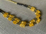 side view of gemstone bead necklace comprising yellow citrine, dark bronze and golden pyrite