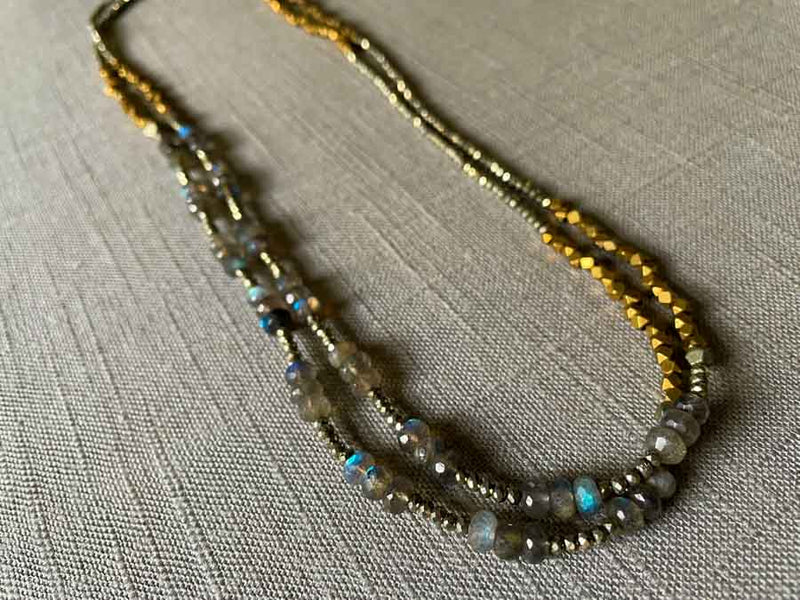 top view of gemstone bead necklace comprising blue labradorite, bronze and pyrite