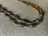 side view of gemstone bead necklace comprising blue labradorite, bronze and pyrite