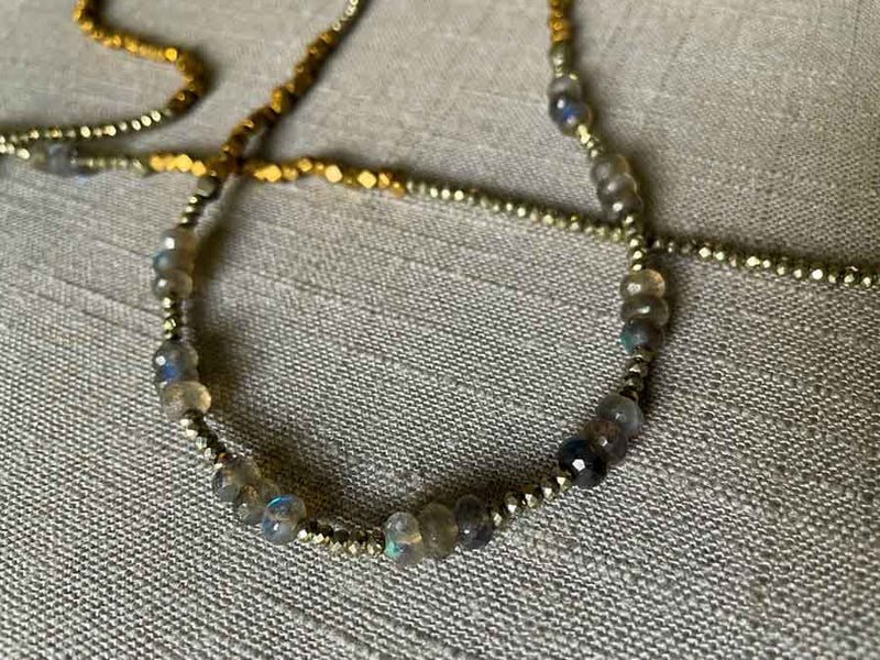 closeup of gemstone bead necklace comprising blue labradorite, bronze and pyrite