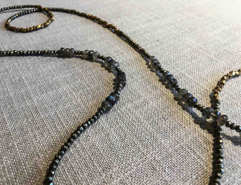 closeup of gemstone bead necklace comprising grey moonstone, bronze and pyrite