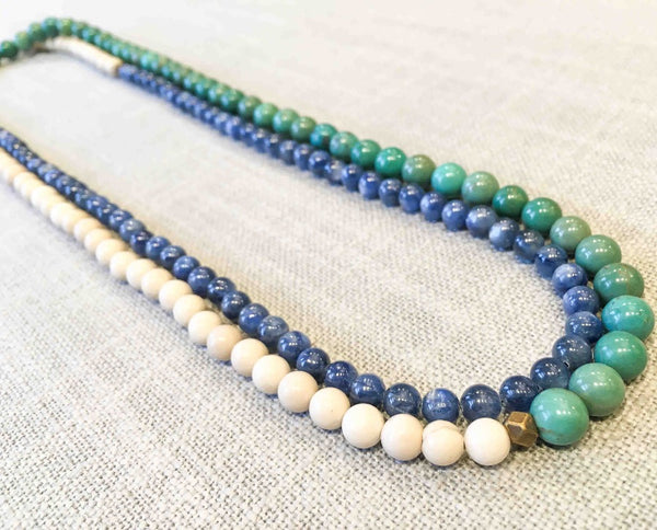 top view of gemstone bead necklace comprising turquoise, white fossil jasper and blue kyanite