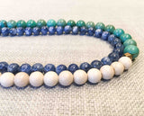 side view of gemstone bead necklace comprising turquoise, white fossil jasper and blue kyanite