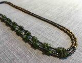 top view of gemstone bead necklace comprising peridot, bronze and pyrite