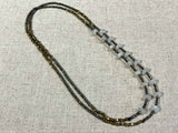 top view of gemstone bead necklace comprising moonstone, pyrite and bronze