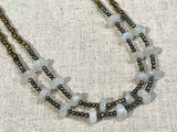 side view of gemstone bead necklace comprising moonstone, pyrite and bronze