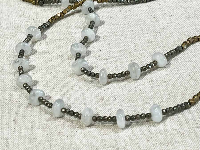 closeup of gemstone bead necklace comprising moonstone, pyrite and bronze