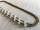 top view of gemstone bead necklace comprising white moonstone, bronze and pyrite