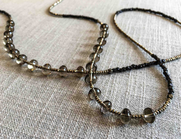 closeup of gemstone bead necklace comprising smoky quartz, dark bronze and golden metallics