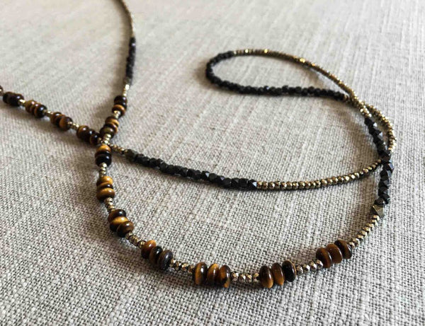 closeup of gemstone bead necklace comprising brown tigers eye, dark bronze and golden pyrite