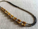 top view of gemstone bead necklace comprising yellow jade, dark bronze and golden pyrite