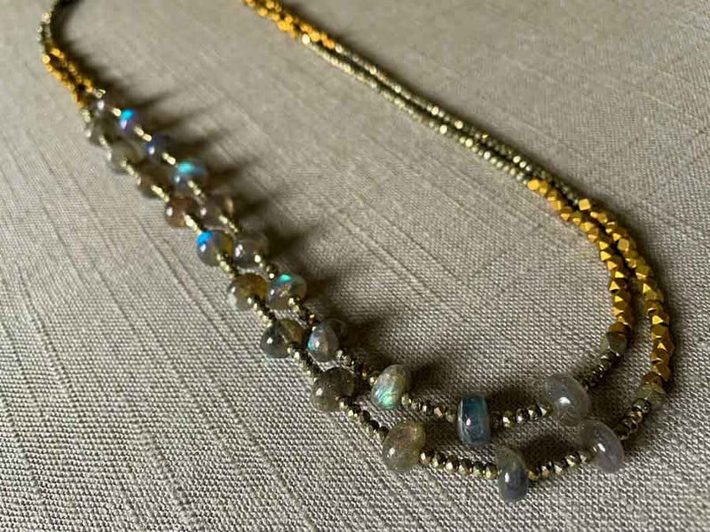 top view of gemstone bead necklace comprising blue labradorite, bronze and dark grey pyrite