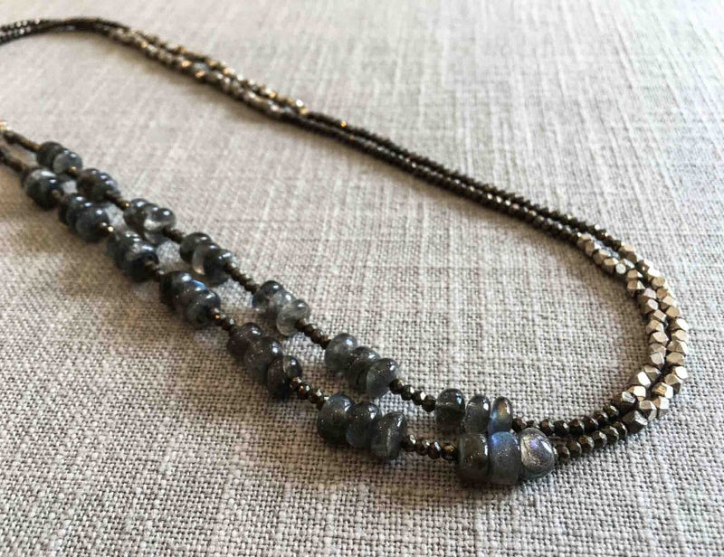 top view of gemstone bead necklace comprising blue labradorite, silver and dark grey pyrite