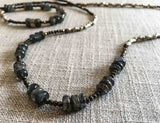 closeup of gemstone bead necklace comprising blue labradorite, silver and dark grey pyrite