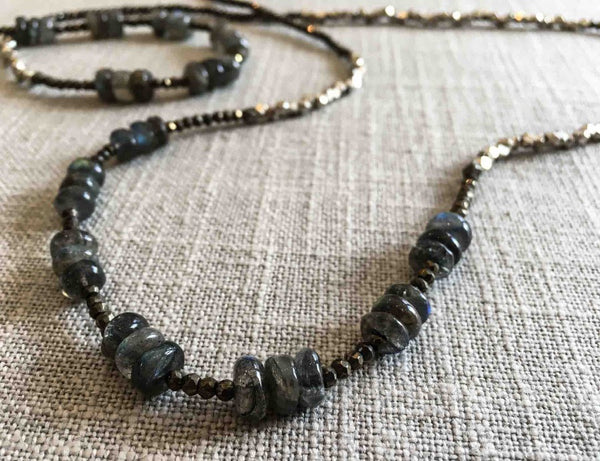 closeup of gemstone bead necklace comprising blue labradorite, silver and dark grey pyrite