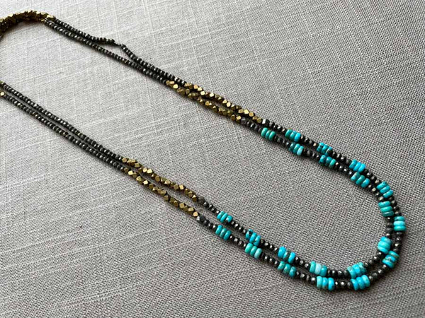 top view of gemstone bead necklace comprising turquoise, bronze and dark grey pyrite