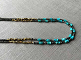 side view of gemstone bead necklace comprising turquoise, bronze and dark grey pyrite