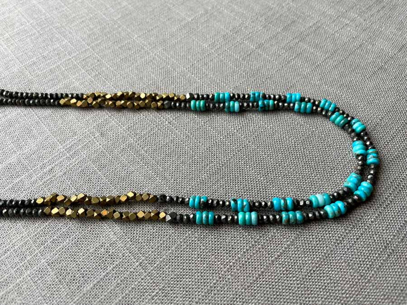 side view of gemstone bead necklace comprising turquoise, bronze and dark grey pyrite