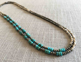 top view of gemstone bead necklace comprising turquoise, silver and dark grey pyrite