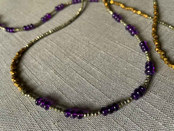 side view of gemstone bead necklace comprising purple amethyst, bronze and dark grey pyrite