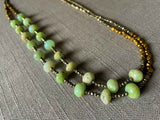 top view of gemstone bead necklace comprising green chrysoprase, bronze and dark grey pyrite