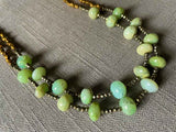 side view of gemstone bead necklace comprising green chrysoprase, bronze and dark grey pyrite