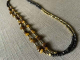 top view of gemstone bead necklace comprising brown horn, dark bronze and golden pyrite