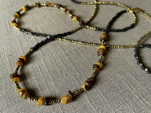 closeup of gemstone bead necklace comprising brown horn, dark bronze and golden pyrite