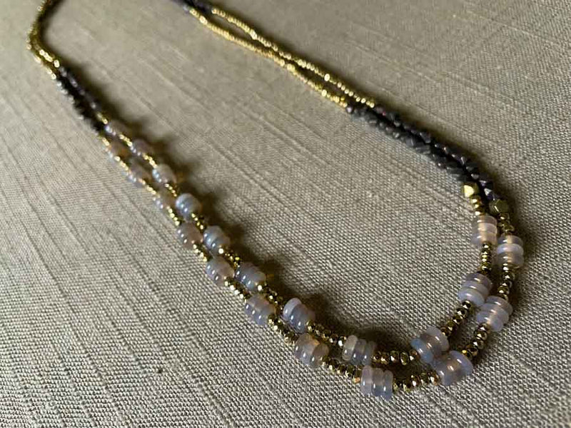 top view of gemstone bead necklace comprising grey moonstone, dark bronze and golden pyrite