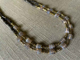 side view of gemstone bead necklace comprising grey moonstone, dark bronze and golden pyrite