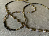 closeup of gemstone bead necklace comprising grey moonstone, dark bronze and golden pyrite