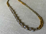 top view of gemstone bead necklace comprising grey moonstone, bronze and dark grey pyrite