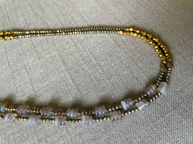 side view of gemstone bead necklace comprising grey moonstone, bronze and dark grey pyrite