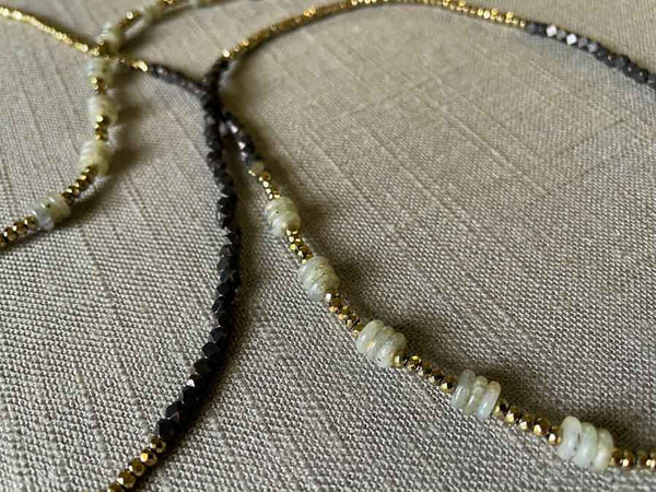 closeup of gemstone bead necklace comprising grey labradorite, dark bronze and golden pyrite