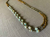 top view of gemstone bead necklace comprising blue amazonite, bronze and dark grey pyrite