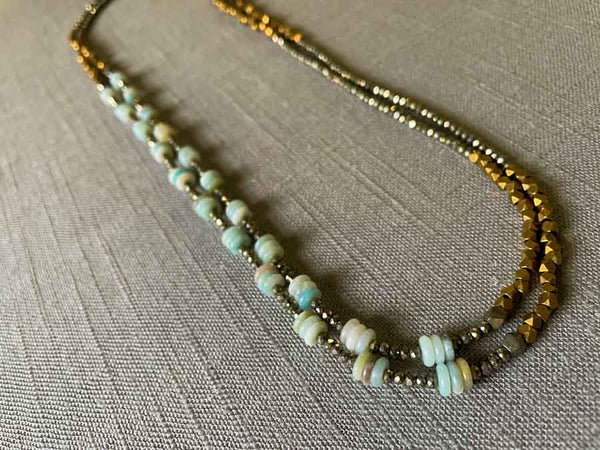 top view of gemstone bead necklace comprising blue amazonite, bronze and dark grey pyrite