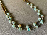 side view of gemstone bead necklace comprising blue amazonite, bronze and dark grey pyrite