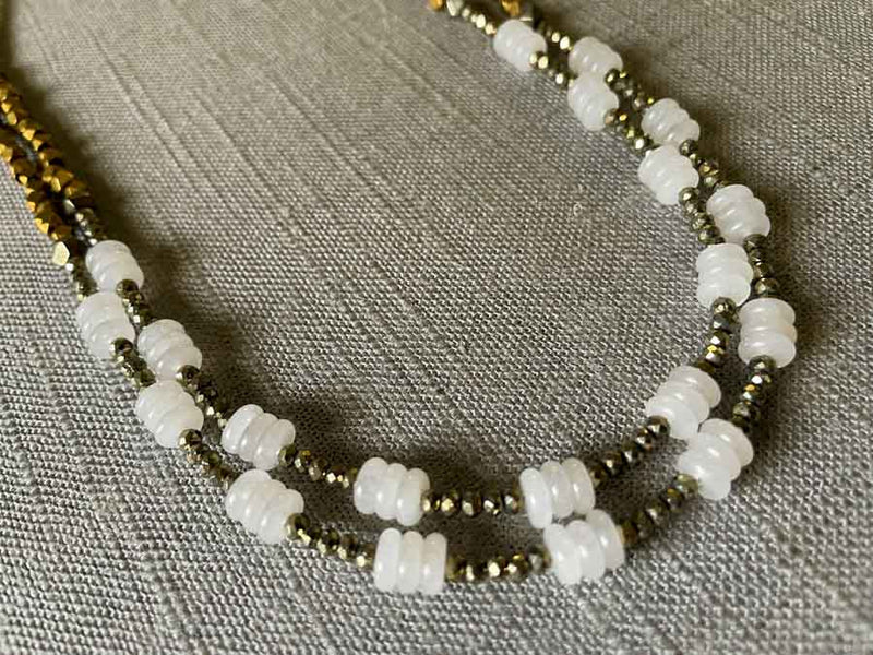 side view of gemstone bead necklace comprising white moonstone, bronze and dark grey pyrite