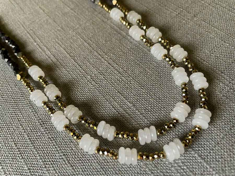 side view of gemstone bead necklace comprising white moonstone, dark bronze and golden pyrite