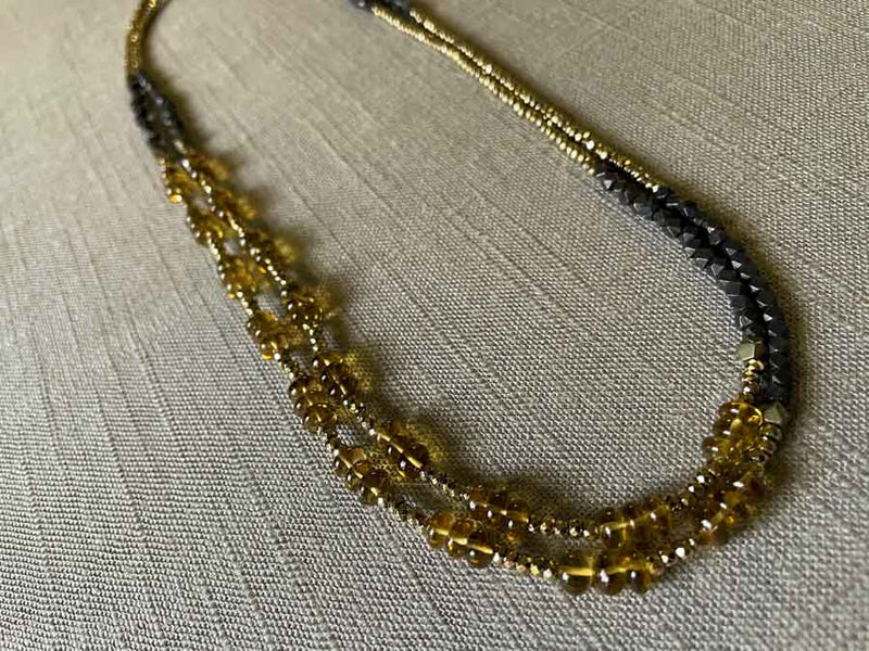 top view of gemstone bead necklace comprising whiskey quartz, dark bronze and golden pyrite