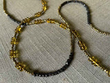 closeup of gemstone bead necklace comprising whiskey quartz, dark bronze and golden pyrite