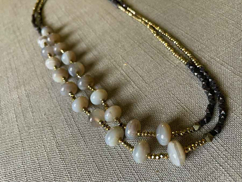 top view of gemstone bead necklace comprising grey moonstone, dark bronze and golden pyrite