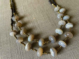 side view of gemstone bead necklace comprising grey moonstone, dark bronze and golden pyrite